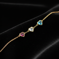 Gold heart bracelet on black velvet